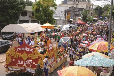 A large crowd is cheering at Pi Mai, Lao New Year festival. Source: KPL